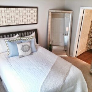 A beautiful light bedroom with a connected bathroom.
