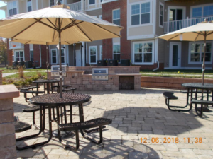 A look at at the outdoor kitchen and and outdoor tables at the Riverwalk Apartments.