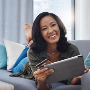 person smiling holding tablet