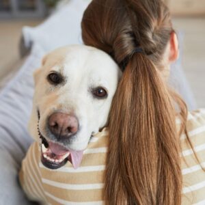 woman hugging dog