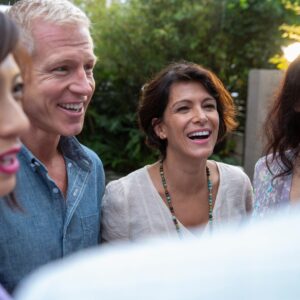 Group of people standing and laughing together