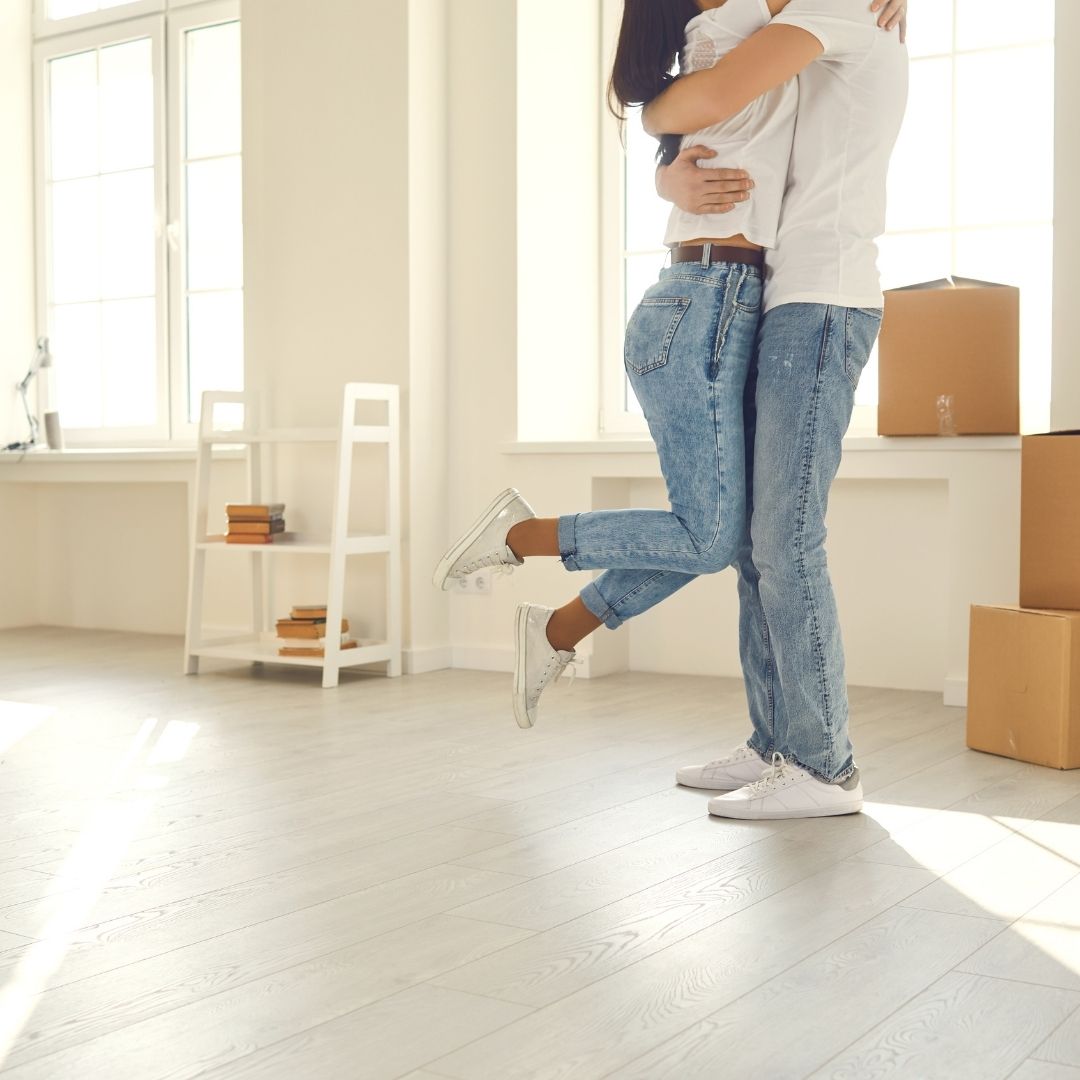 happy couple hugging in new apartment