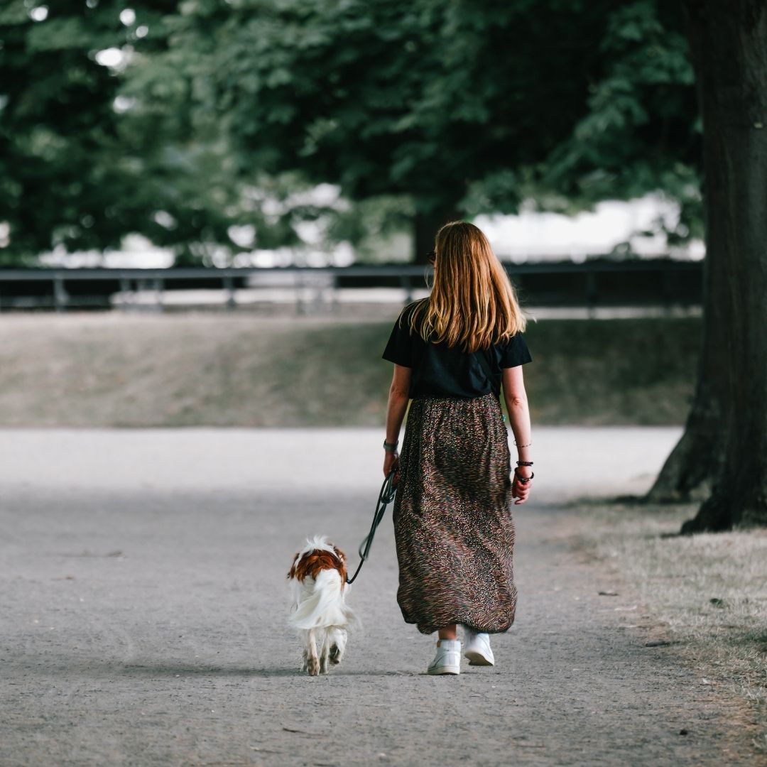 A woman walking her dog.