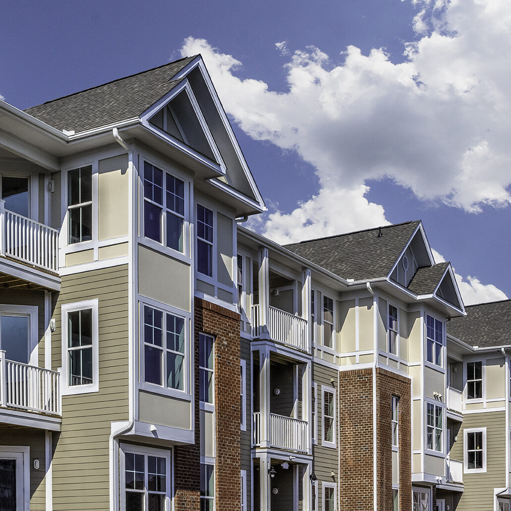 A view of the Riverwalk Apartments against a beautiful blue sky.